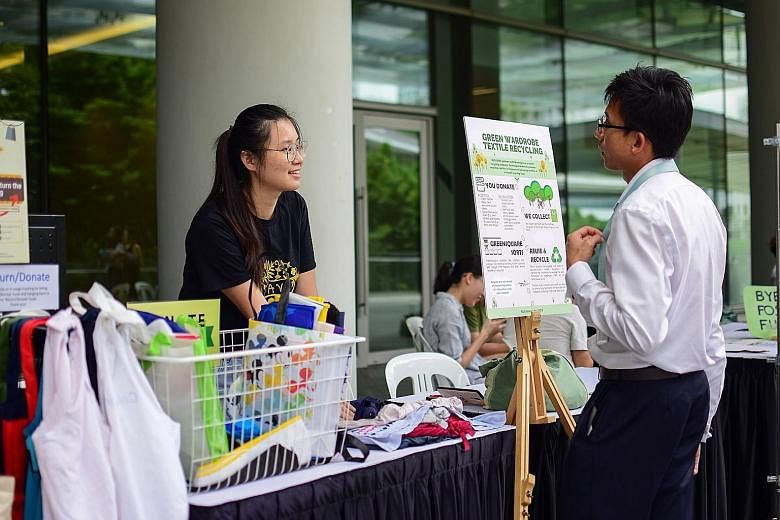 A booth at an NUS Save event with a poster about the textiles recycling programme. An online survey of 4,097 Singapore respondents by research agency YouGov in 2017 found that 73 per cent had thrown away clothes in the past year while 34 per cent had