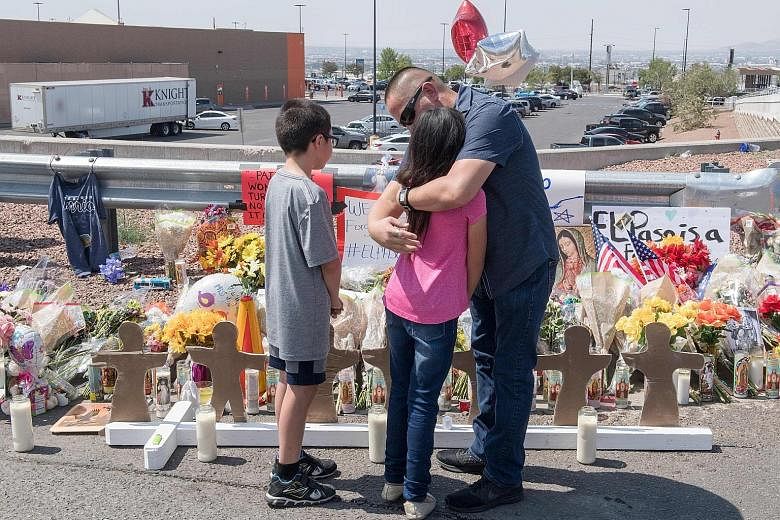 A family at a makeshift memorial for victims of the El Paso shooting. Domestic terrorism is an urgent issue at a time when white supremacists are causing more murders than Americans inspired by foreign groups.