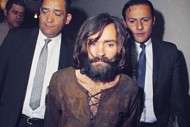 Charles Manson (far left, foreground, in a 1969 file photo) being escorted to his arraignment on conspiracy-murder charges. Manson (left, in a 2017 file photo) died in prison on Nov 19, 2017.