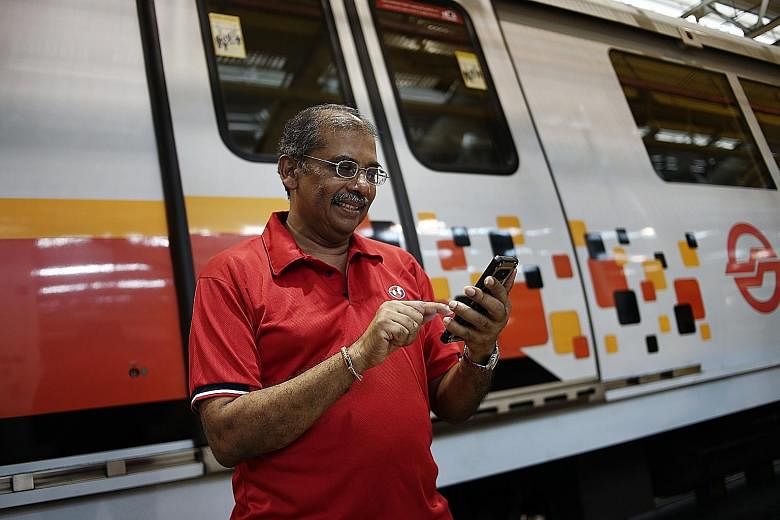 SMRT senior station manager Krishnasamy Suriyakhanu said he learnt how to use mobile apps to submit medical claims and check his payslip during the pilot class of the SkillsFuture Digital Workplace Programme. (From left) National Transport Workers' U