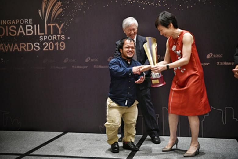 Above: Sportswoman of the Year Yip Pin Xiu holding her trophies at the awards ceremony last night. Left: A jubilant Muhammad Diroy Noordin receiving his Sportsman of the Year trophy from Culture, Community and Youth Minister Grace Fu.