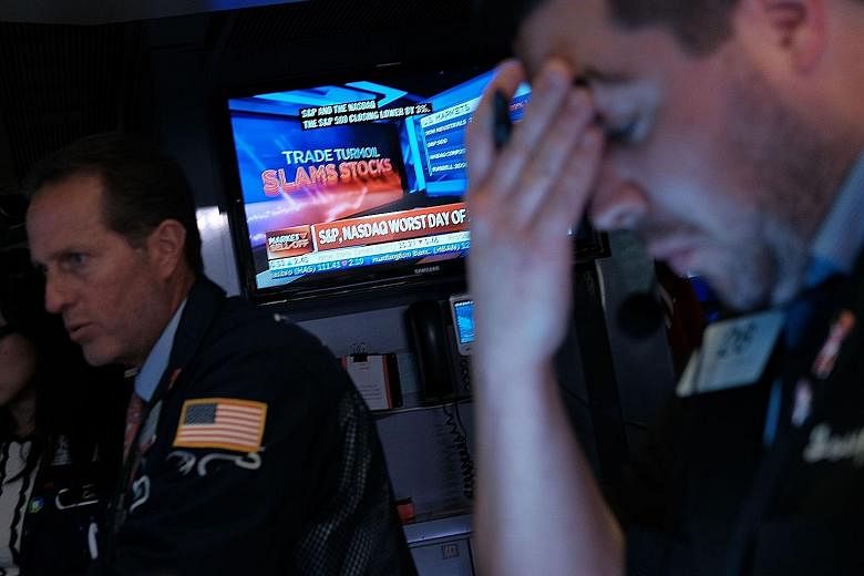 A trader on the floor of the New York Stock Exchange on Monday, when all three major US stock indexes nose-dived.