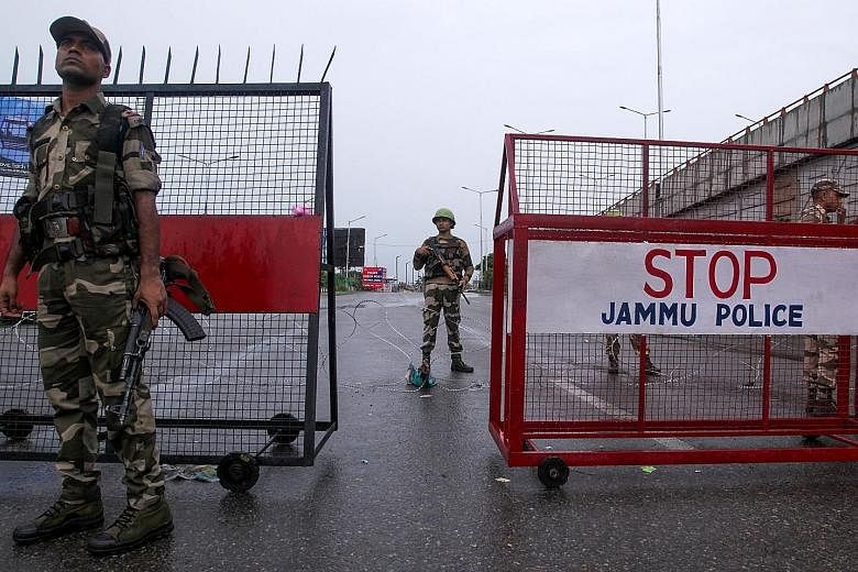 Security personnel at a roadblock in Jammu yesterday. The US has called for peace and stability along the de facto border between India and Pakistan, amid anticipation of heightened tensions. Hindu activists scuffling with policemen after trying to d