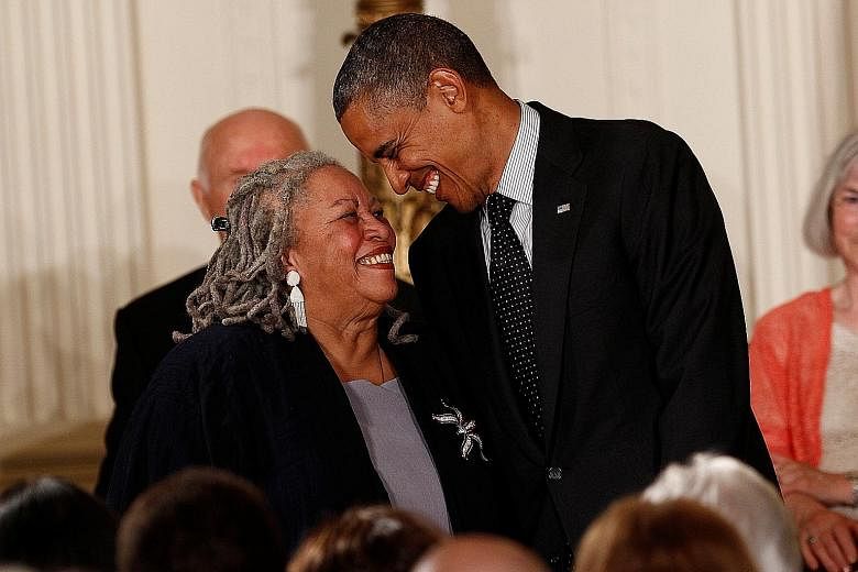In a 2012 file photo, then United States President Barack Obama awards novelist Toni Morrison (both right) the Presidential Medal of Freedom at the White House.