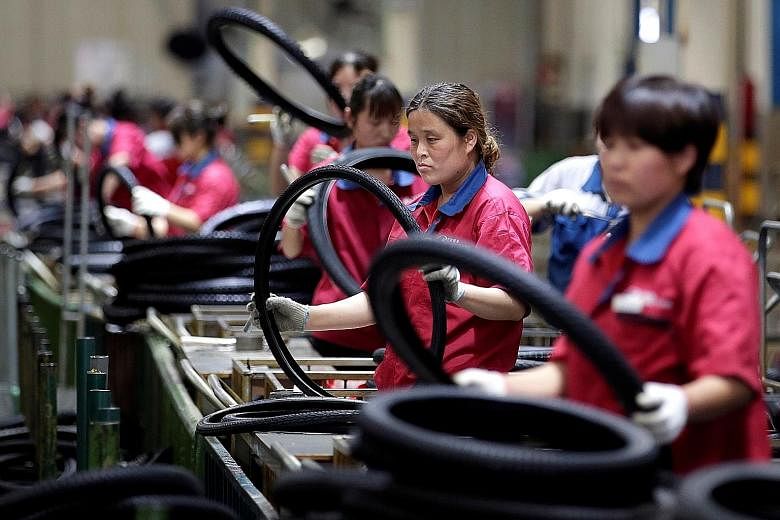 Workers at a tyre factory in China's Hebei province that exports its products to countries such as the US and Japan. A sharp drop in the yuan currency this week may offer only scant relief for Chinese exporters, who are facing both additional US levi