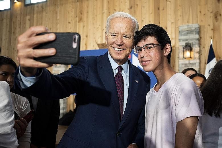 US Democratic presidential candidate Joe Biden with a supporter during a campaign event in Burlington, Iowa, yesterday. PHOTO: DPA