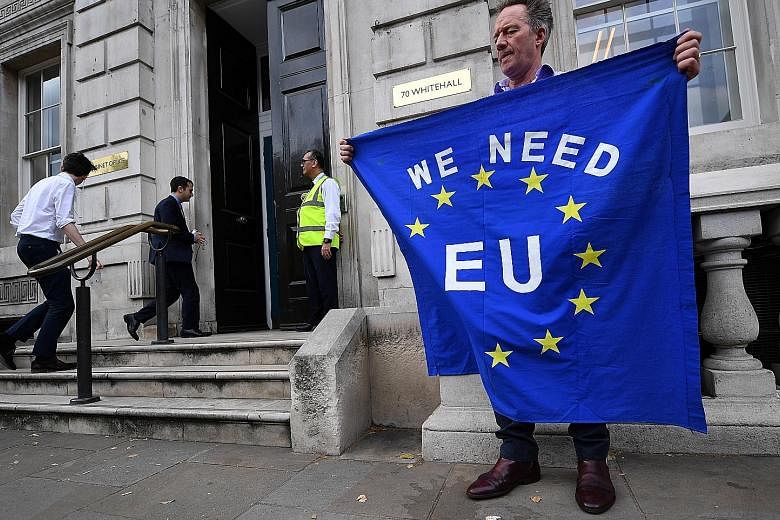 A pro-EU campaigner outside the Cabinet Office in London on Wednesday. British Prime Minister Boris Johnson has vowed to take Britain out of the EU by the deadline, even if it means doing so without an agreement.