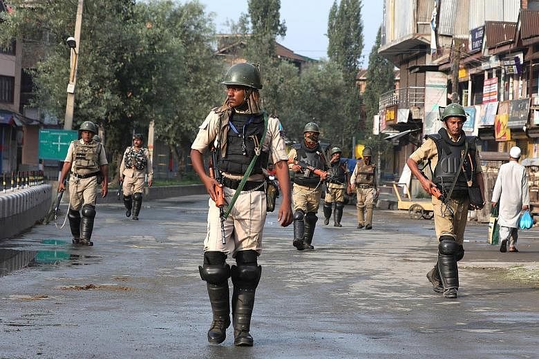 Indian paramilitary soldiers on patrol in Srinagar on Wednesday. An unprecedented security lockdown amid a near-total communications blackout entered a fourth day yesterday, following the decision by New Delhi to revoke the special status of Jammu an