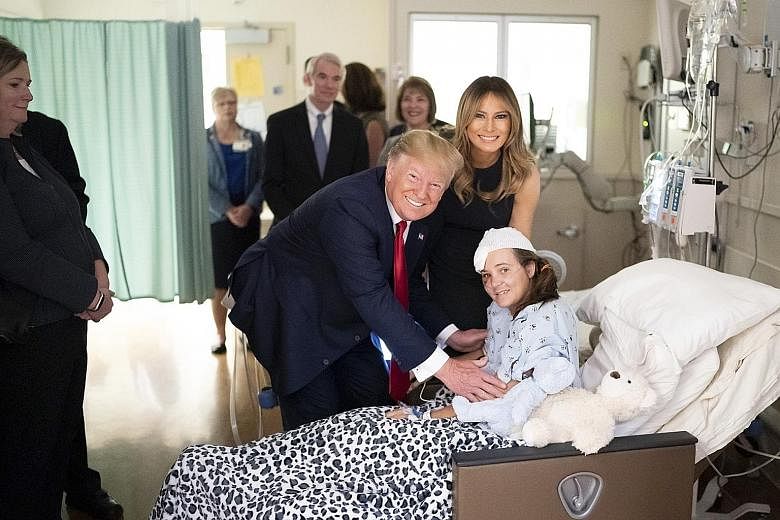 US President Donald Trump and First Lady Melania Trump with a survivor at Miami Valley Hospital, where the wounded were treated after nine people and the suspect were killed in the rampage in Dayton, Ohio, early last Sunday.