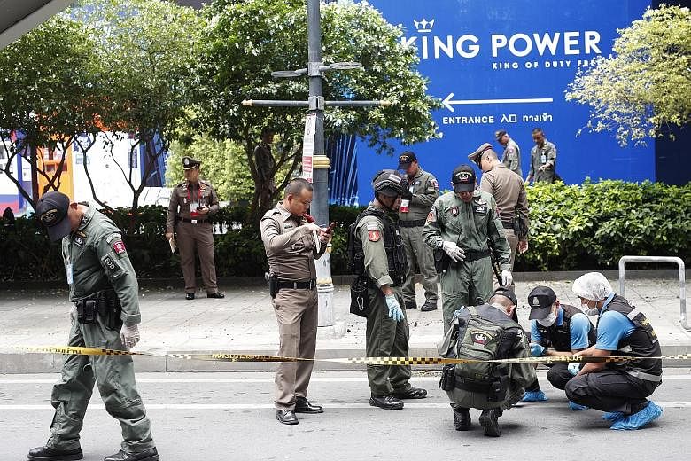 Thai bomb squad members and forensic police officers inspecting the area where a small bomb exploded in Bangkok last Friday. "We need to find the masterminds, but it's not easy," said Police Lieutenant-General Suwat Chaengyotsuk.
