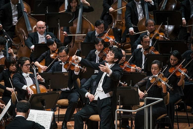 In a photo taken in 2016, conductor laureate Lan Shui is seen leading the Singapore Symphony Orchestra during a performance in Berlin.