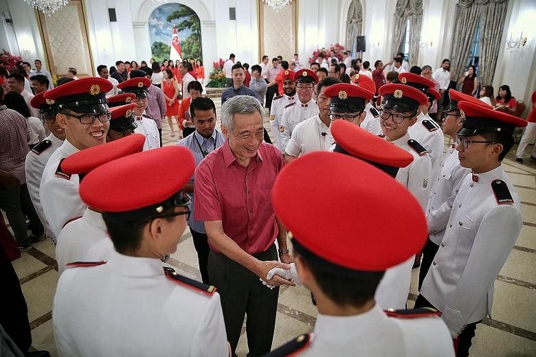 Prime Minister Lee Hsien Loong meeting Presidential Guards from the Military Police during the National Day Observance Ceremony at the Istana yesterday. ST PHOTO: KEVIN LIM