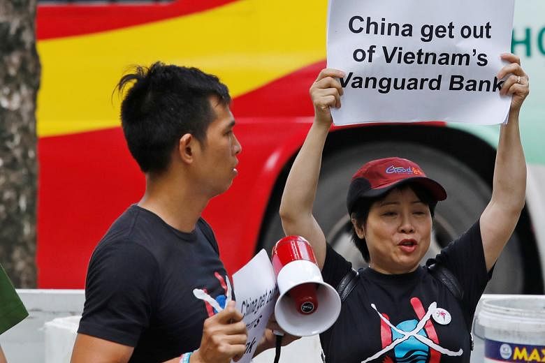 Protesters in Hanoi rallying against China's presence in the Vanguard Bank area of the South China Sea on Tuesday. Vietnam said China's Haiyang Dizhi 8 vessel has left its continental shelf.