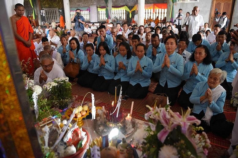 Relatives of former Khmer Rouge leader Nuon Chea praying during his funeral procession in Pailin, Cambodia, yesterday.