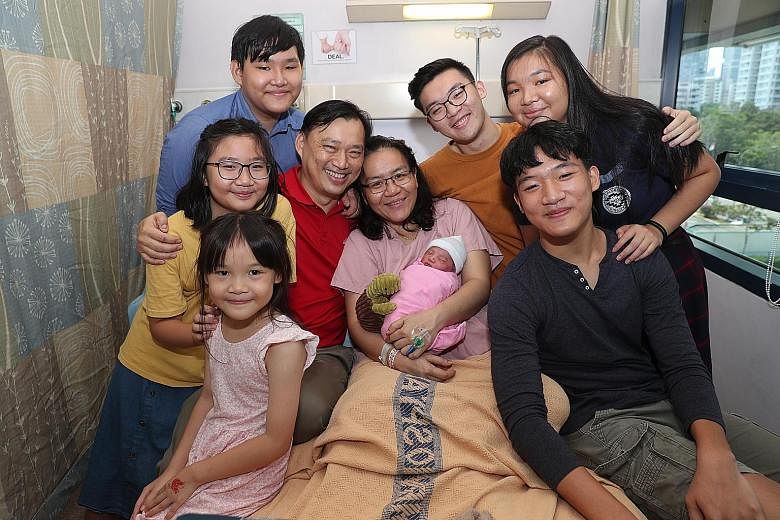 The Ong siblings (clockwise from left) Michaela, seven; Magdalena, 10; Isaiah, 13; Asher, 19; Abigail, 17; and Isaac, 15, surrounding their parents - programme manager and educator Dan Ong, 48, and Mrs Sue Ong, 44, a housewife, who is holding newborn