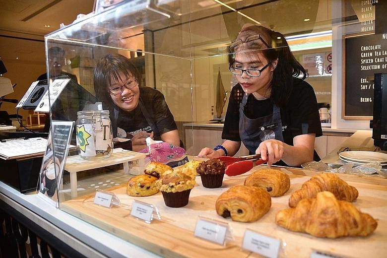 The Special Employment Credit scheme offers a monthly wage subsidy of about $200 to employers for every employee with a disability who is hired, like Ms Carmen Tan Yin Xin (left), 23, and Ms Rachael Lum Yuan Ting, 19, who work at Foreword Coffee. But