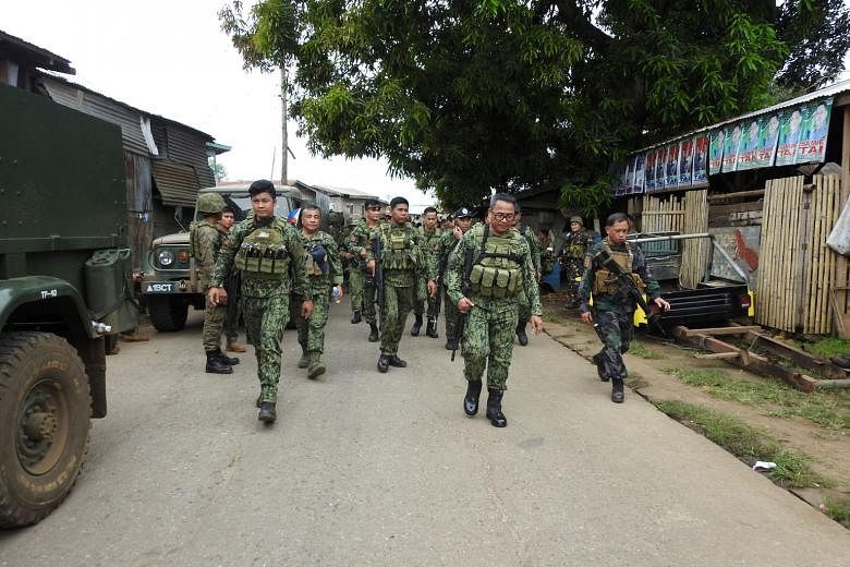 Officials and police staff heading for Indanan town, Sulu, on June 28 to conduct an investigation. A blast had left eight people dead and 12 wounded. Militants are seeking to bomb targets in Luzon, and with other threats, such as some 200 Indonesians
