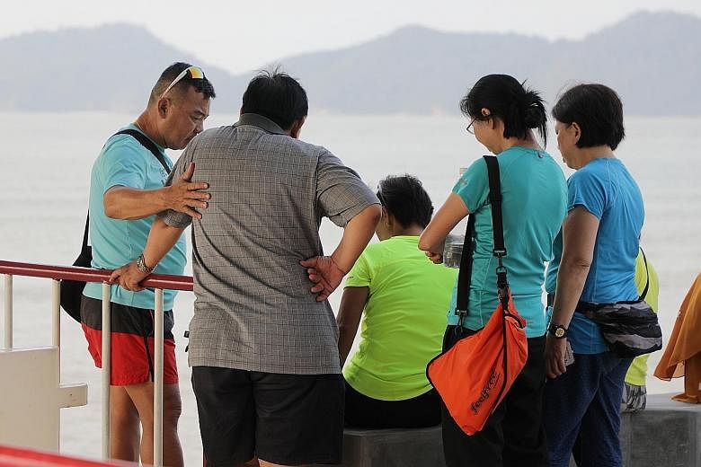 Family members of the missing pair keeping vigil. Conditions around Endau islands were rough when Mr Tan Eng Soon, 62, and Madam Puah Geok Tin, 57, went missing. Madam Puah's son was a participant in Friday's NDP. Search operations being carried out 