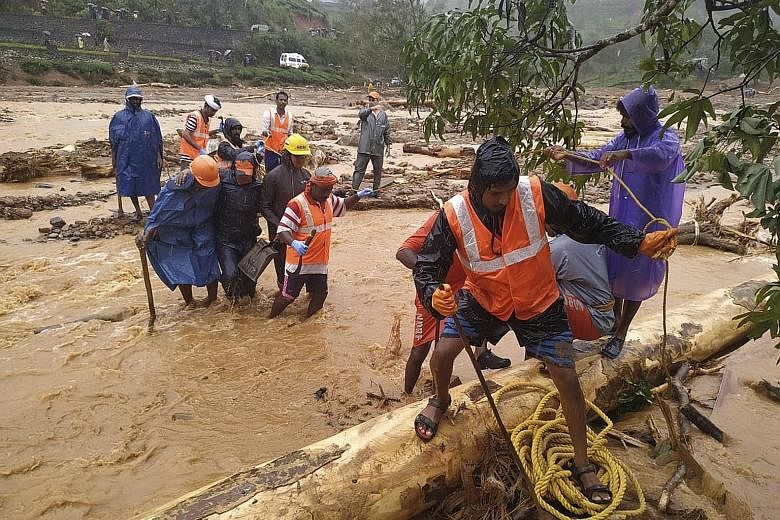 National Disaster Response Force personnel helping to evacuate flood victims to safer areas in Wayanad district, in the southern state of Kerala. PHOTO: ASSOCIATED PRESS