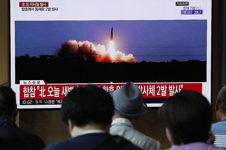 A news broadcast in Seoul on North Korea's missile launch yesterday. The projectiles were fired at dawn from an area around the city of Hamhung, said South Korea's Joint Chiefs of Staff. PHOTO: EPA-EFE