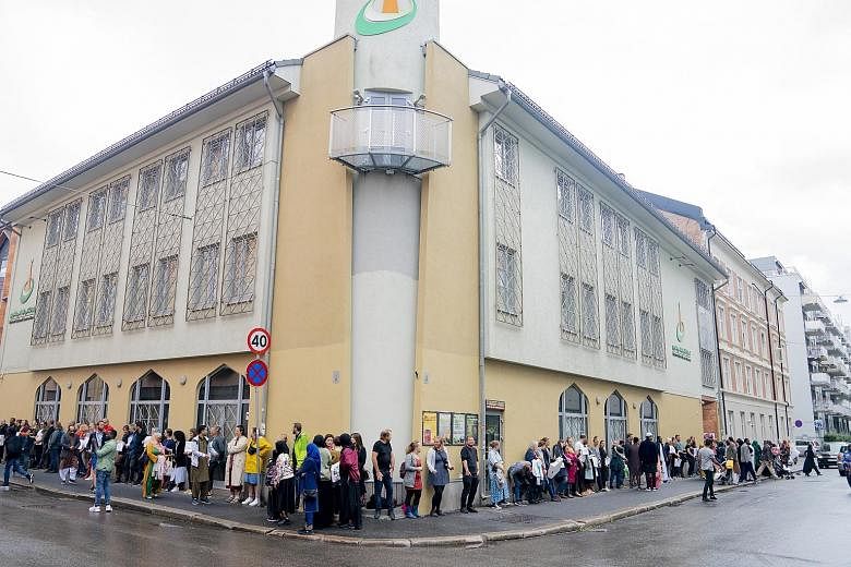 People showing their solidarity with the al-Noor Islamic Centre by standing outside the Norwegian mosque yesterday, a day after a gun attack at the place of worship. The police said the suspected attacker - a young, white male carrying several guns -