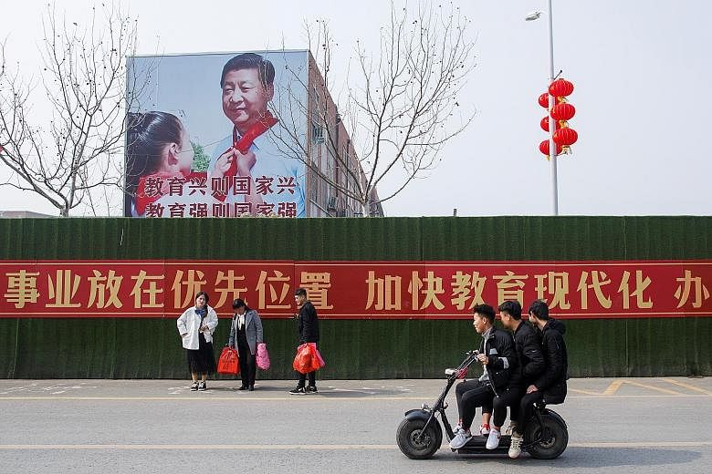 A giant wall poster showing Chinese President Xi Jinping on the side of a school building in Lankao county, Henan province. In the short run, China's government has ample firepower to prevent economic growth from falling below the 6 per cent lower bo
