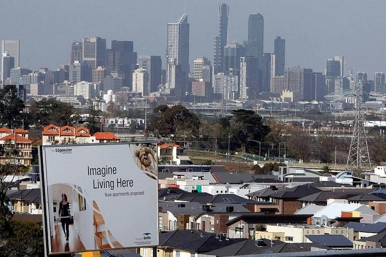 A billboard for a housing project, with the Melbourne skyline in the distance. Despite stable price rises last month, property values across Australia have plunged since their peak about two years ago.