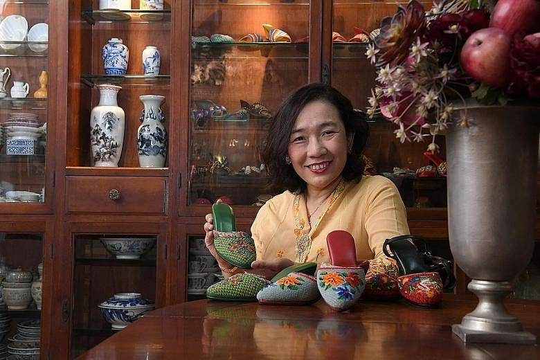 Ms Angeline Kong with her great-grand-aunt's green kasut manek (Peranakan beaded shoes) and two newer pairs that she made herself. ST PHOTO: DESMOND FOO