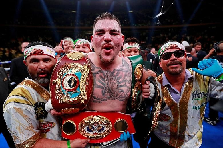 American heavyweight boxer Andy Ruiz Jr celebrating with the belts after defeating Briton Anthony Joshua in their fight at Madison Square Garden in New York in June.