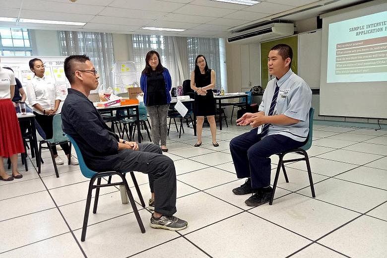 Northbrooks Secondary School principal Nick Chan (left) doing a mock interview with Secondary 3 student Ding Zhao Yang in a workshop organised by Access. The group's pilot run in June involved 19 students.