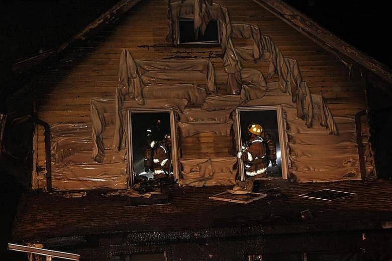Firefighters at the daycare centre in Erie, Pennsylvania, on Sunday. The US city's fire chief said the five children, aged eight months to seven years, were sleeping in second-floor bedrooms when the blaze broke out. He said investigators were "leani