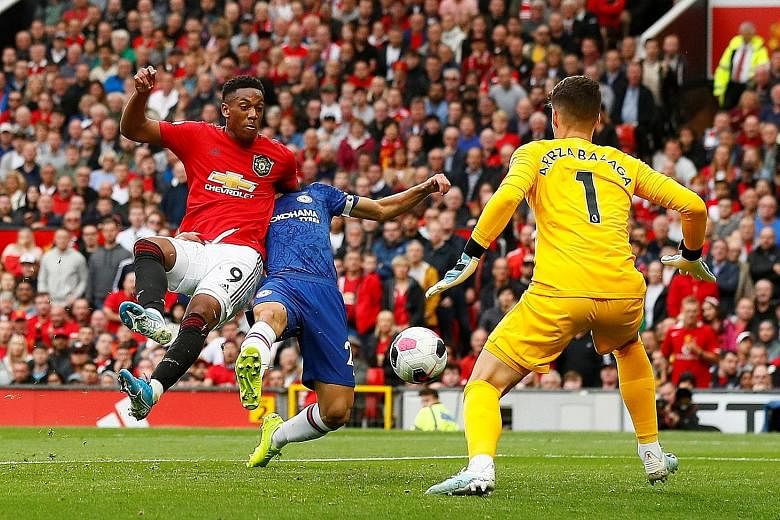 Anthony Martial holding off a challenge from Cesar Azpilicueta to knock home their second goal past Chelsea goalkeeper Kepa.