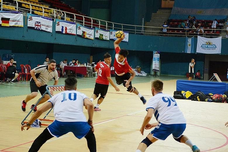 Singapore's Nico Quek (with the ball) and Low Ee Tuck attempting to score in their 55-53 loss to Italy at the World Tchoukball Championships semi-final in Negeri Sembilan. Singapore won the bronze by defeating Macau in the third-place play-off. PHOTO
