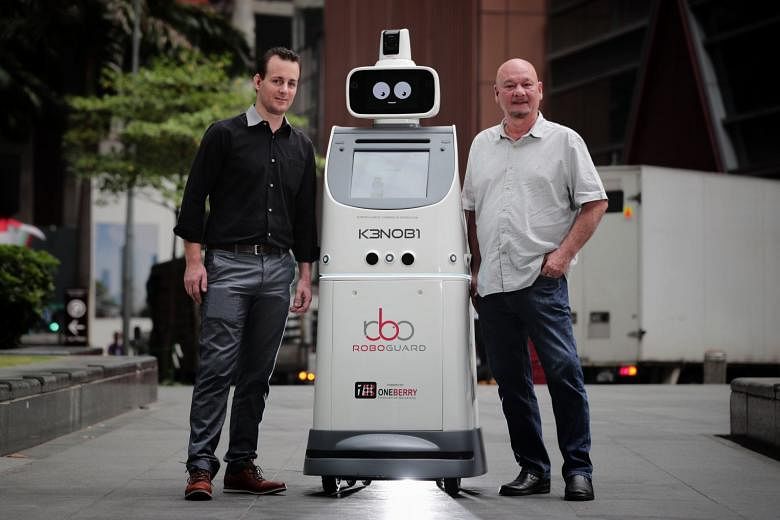 KenOBI the RoboGuard, an autonomous security, concierge and events robot that augments and enhances the work of security officers, with Oneberry CEO Ken Pereira (right) and CTO Julien Lenser-Hobbs.