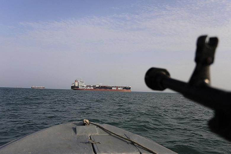 In this photo taken on July 21, an Iranian Revolutionary Guard boat has its sights trained on British oil tanker Stena Impero, which was seized in the Strait of Hormuz on July 19. PHOTO: ASSOCIATED PRESS