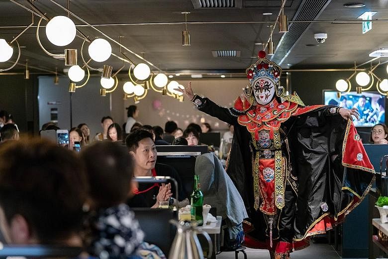 Haidilao lures customers with perks such as this performance by a face-changing artist. The stock has surged more than 78 per cent since its Hong Kong listing last September. The Sichuan-based restaurant chain's revenue nearly tripled in the past thr
