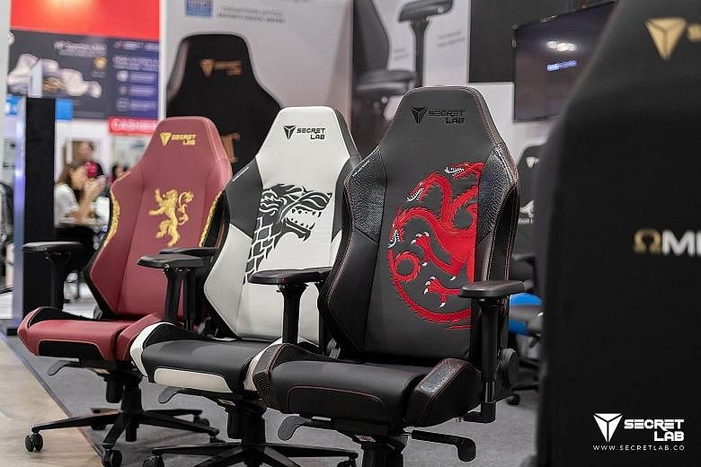 Secretlab's gaming chairs range from synthetic leather options for $429 to full leather designs for about $1,000. Secretlab founders Alaric Choo (wearing cap) and Ian Alexander Ang started the company in 2014, and its gaming chairs are now available 