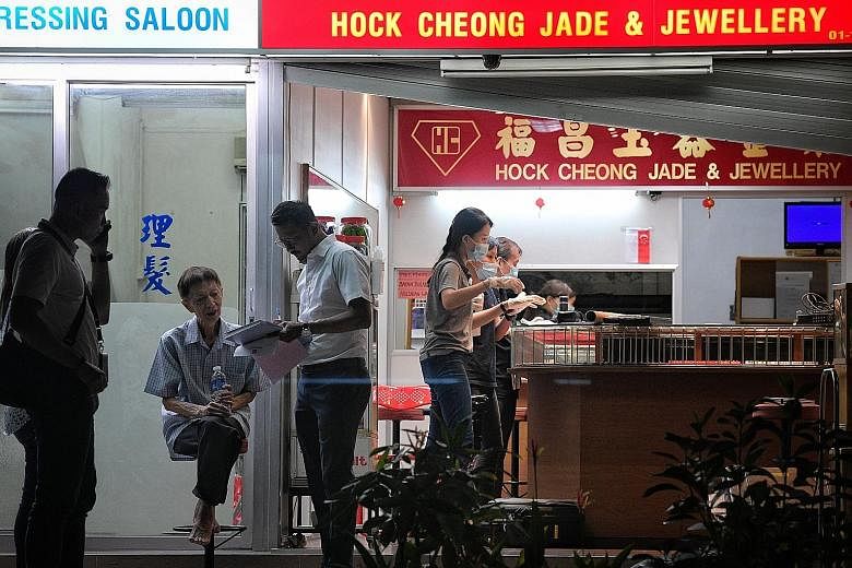 Police conducting investigations at Hock Cheong Jade & Jewellery shop in Ang Mo Kio Avenue 10, where a robbery took place at around 4pm yesterday.