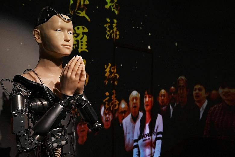 Mindar, the robot priest, is able to move its torso, arms and head. But only its hands, face and shoulders are covered in silicone to replicate human skin. Wiring and blinking lights fill the cranial cavity of its open-top head and snake around its g