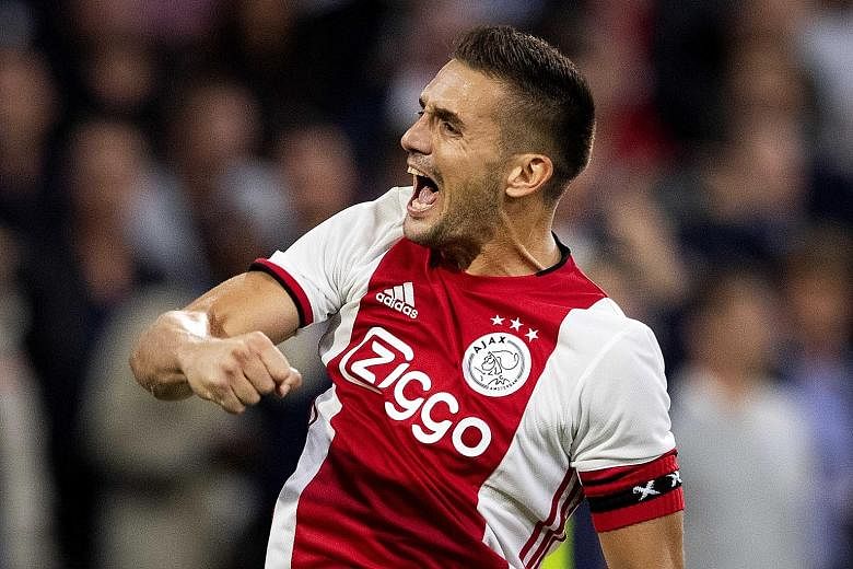 Ajax's Dusan Tadic celebrating one of two successful spot kicks in their 3-2 win over Paok in the second leg of their Champions League third qualifying round on Tuesday. The captain had missed another penalty but last season's semi-finalists advanced