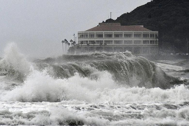 High waves pounding a beach in Miyazaki, south-western Japan, on Tuesday as tropical storm Krosa approaches the country, causing disruptions to hundreds of flights and bullet train services.