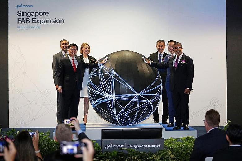 Deputy Prime Minister and Minister for Finance Heng Swee Keat and Micron president and CEO Sanjay Mehrotra (far right) at the opening of Micron's expanded facility yesterday. With them are (from left) Micron executive vice-president of global operati
