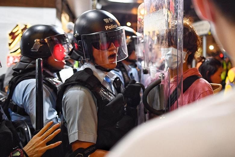 Hong Kong protesters apologising yesterday for the clashes with police at the airport on Tuesday, which resulted in hundreds of cancelled flights and thousands of stranded passengers. PHOTO: REUTERS Hong Kong police dispersing a gathering of proteste