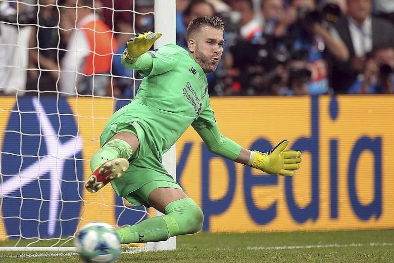 Left: Liverpool goalkeeper Adrian is the toast of his teammates after his save sealed a 5-4 penalty shoot-out win over Chelsea in the Uefa Super Cup match. It ended 2-2 in extra time on Wednesday. PHOTO: DPA Below: Adrian, who spent the bulk of last 