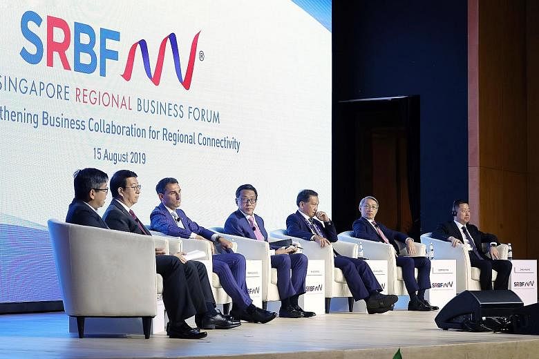 Banyan Tree Holdings executive chairman Ho Kwon Ping (centre) moderating the plenary session of the Singapore Regional Business Forum yesterday, with the panel comprising (from left) GIC managing director Boon Chin Hau, China International Capital Co
