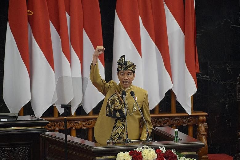 Indonesian President Joko Widodo, in the traditional attire of the Sasak tribe from Lombok island, delivering a speech in Parliament in Jakarta yesterday, ahead of the country's Independence Day today.