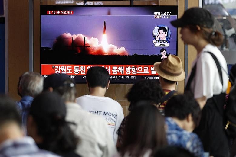South Koreans watching a broadcast in Seoul of North Korea's missile launch yesterday. It was the sixth round of launches in recent weeks in protest against ongoing joint military drills between South Korea and the United States. PHOTO: EPA-EFE