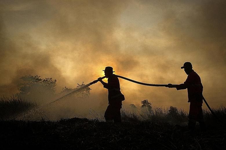 Indonesian firefighters battling a fire earlier this month at a peatland forest in Ogan Ilir, South Sumatra. The Indonesian authorities are deploying thousands of extra personnel to prevent a repeat of the 2015 fires, which were the worst for two dec