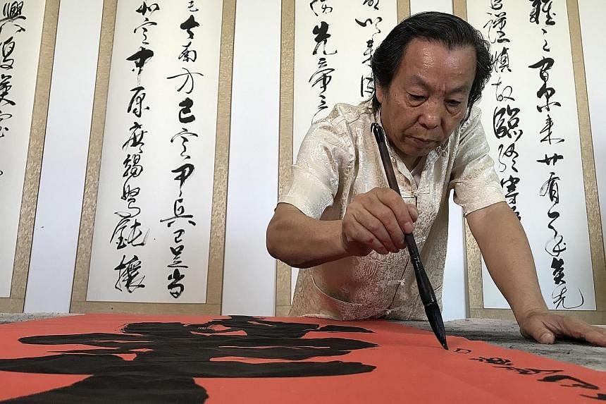 Although he was not born ambidextrous, in 1990, the right-handed Mr Li Ying started training himself to write with his left hand, practising at least 10 hours a day and often forgetting to eat. ST PHOTO: BENJAMIN KANG LIM