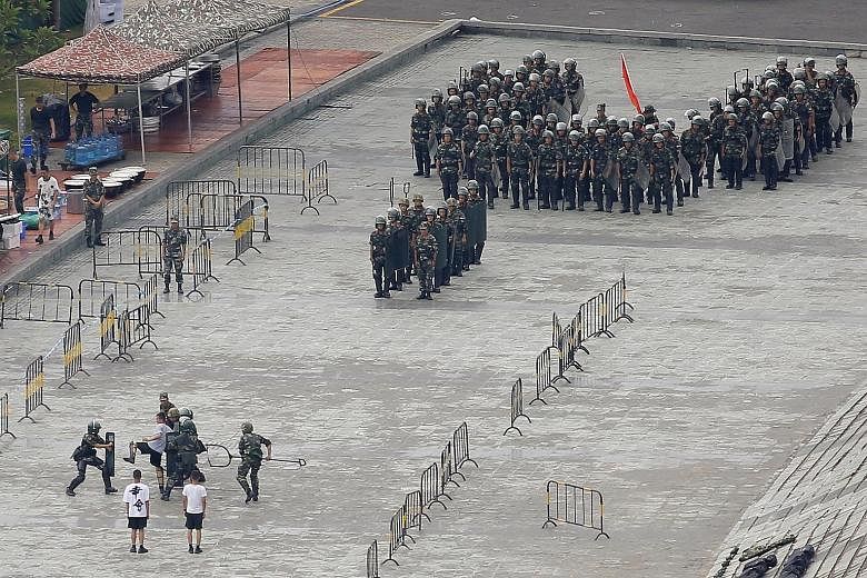 Chinese servicemen attending a crowd-control exercise on Friday in Shenzhen, across the border from Hong Kong. As protests have grown more violent, Beijing has mustered paramilitary forces in Shenzhen, and its condemnation of Hong Kong's demonstrator